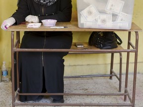 An election worker waits for voters at a polling station during the second day of the presidential in Cairo, Egypt, Tuesday, March 27, 2018. Egyptians were voting Tuesday on the second day of a lackluster election that President Abdel-Fattah el-Sissi is virtually certain to win after all serious rivals were either arrested or intimidated into dropping out of the race ahead of balloting.