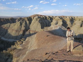 Scott Wing examines a fossil in the Bighorn Basin, Wyoming. Scientists seek evidence of 56-million-year-old climate catastrophe.