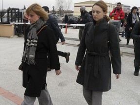 Sotiria Theocharidi, Greece's Consul in Edirne, left, arrives at the courthouse in Edirne, Turkey, Monday, March 5, 2018. Lawyers have formally appealed for the release of two arrested Greek soldiers from custody. The two were arrested last week for allegedly entering a Turkish military zone and on suspicion of attempted espionage. Greece said the two soldiers - a lieutenant and a sergeant - accidentally strayed into Turkey during a patrol of the Greek-Turkish border due to bad weather.