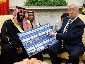 Donald Trump shows a chart highlighting arms sales to Saudi Arabia during a meeting with Saudi Crown Prince Mohammed bin Salman in the Oval Office at the White House, Tuesday, March 20, 2018.