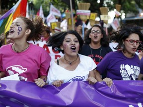 Women shout slogans during an International Women's Day march in Asuncion, Paraguay, Thursday, March 8, 2018. Women marched to protest violence against women.
