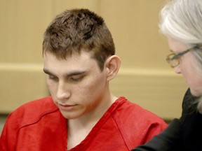 FILE - In this Feb. 19, 2018 file photo, Nikolas Cruz, accused of murdering 17 people in the Florida high school shooting, appears in court for a status hearing in Fort Lauderdale, Fla. Cruz was formally charged Wednesday, March 7, with 17 counts of first-degree murder, which could mean a death sentence if he is convicted.