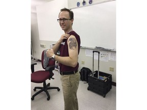 CORRECTS SPELLING OF LAST NAME FROM KUSHUV TO KASHUV - In this photo released by Kyle Kashuv,  Frank Krar, a statistics teacher at Marjory Stoneman Douglas High School displays his new tattoo in the campus, Wednesday, Feb. 28, 2018, in honor of the victims of the shooting at the school, in Parkland, Fla. Students returned to the school as classes resumed for the first time since several students and teachers were killed by a former student on Feb. 14.