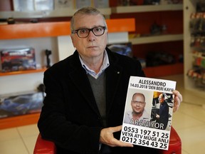 Eligio Fiori, 66, of Italy, holds a poster showing a poster with photographs of his son Alessandro Fiori and reading in Turkish: 'Alessandro is missing since March 14, 2018. Wanted' during an interview with The Associated Press, in Istanbul, Tuesday, March 27, 2018. Turkish authorities and family members are searching for a 33-year Italian man who has disappeared nearly two weeks ago while visiting Istanbul.