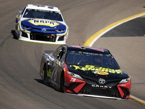 Monster Energy NASCAR Cup Series driver Martin Truex Jr. (78) leads Chase Elliott on the 25th lap during a NASCAR Cup Series auto race on Sunday, March 11, 2018, in Avondale, Ariz.
