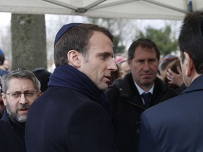 French President Emmanuel Macron arrives for the funerals of Mireille Knoll, Wednesday March 28, 2018 in Bagneux, outside Paris. Family members and friends gathered Wednesday to honor an 85-year-old woman who escaped the Nazis 76 years ago but was stabbed to death last week in her Paris apartment, apparently because she was Jewish.