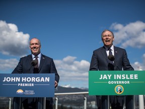 British Columbia Premier John Horgan, left, and Washington State Gov. Jay Inslee attend a news conference about high speed rail, in Vancouver, B.C., on Friday March 16, 2018.