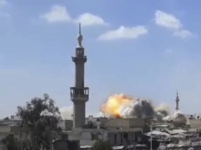 This frame grab from video provided by Syrian rebels Army of Islam media outlet that is consistent with independent AP reporting, shows flames rising from a Syrian government forces airstrike attack, in eastern Ghouta, suburb of Damascus, Syria, Friday, March 9, 2018. Relief workers used a brief lull in Damascus' embattled rebel-held suburbs to try and deliver remaining aid left over from a mission earlier in the week but were interrupted by renewed violence shorty after their team entered eastern Ghouta on Friday.(Army of Islam, via AP)