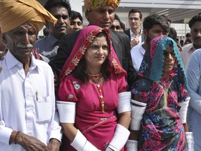 Krishna Kumari, center, newly elected Senator of the Pakistani Hindu Community, arrives at the Parliament with her family members in Islamabad, Pakistan, Monday, March 12, 2018. Pakistan swore in newly elected members of the Senate, including for the first time a woman from the marginalized Hindu minority, as allegations swirled that some senators had bribed their way to become lawmakers.