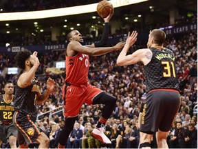Raptors forward CJ Miles drives at Atlanta Hawks forward Mike Muscala during second half NBA basketball action in Toronto on Tuesday.