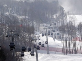 In this Friday, Jan. 22, 2016, file photo, gondolas make their way through a thinned forest up the ski slope which would be the venue for the Pyeongchang 2018 Winter Olympics at the Jeongseon Alpine Center. With the Olympic Games coming to a close, one of the main questions facing South Korea and the consequences of hosting an expensive sports event is the future of the scenic Jeongseon Alpine Center, which was built in a formerly government-protected area where some 60,000 trees were razed.