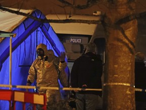 Investigators next to a police tent outside The Mill public house at the Maltings in Salisbury, England, Tuesday, March 6, 2018, near to where former Russian double agent Sergei Skripal was found critically ill.