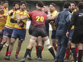 Spain's players, left, clash with Romania referee Vlad Iordachescu, after the Rugby Europe Championship match between Belgium and Spain at the Little Heysel Stadium in Brussels, Sunday, March 18, 2018.