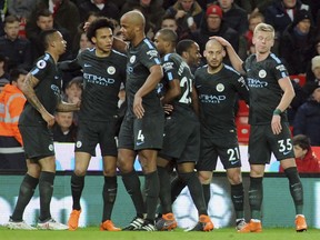 Manchester City's David Silva, second right, celebrates with teammates after scoring his side's first goal during the English Premier League soccer match between Stoke City and Manchester City at the Bet 365 Stadium in Stoke on Trent, England, Monday, March 12, 2018.