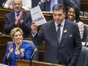 Ontario Finance Minister Charles Sousa delivers the provincial budget while Premier Kathleen Wynne applauds, Wednesday March 28, 2018.