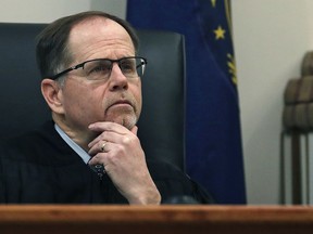 FILE - In this Feb. 13, 2018, file photo, Judge Charles Temple listens to attorney Steven M. Gordon, who represents lottery winner "Jane Doe", during a hearing in the Jane Doe v. NH Lottery Commission case at Hillsborough Superior Court in Nashua, N.H. Temple ruled Monday, March 12, 2018, that the woman who won a Powerball jackpot worth nearly $560 million can keep her identity private, but not her hometown.