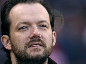 FILE - In this May 3, 2017 file photo, Andris Nelsons, musical director of the Boston Symphony Orchestra, waits before throwing out the ceremonial first pitch before a baseball game at Fenway Park in Boston. Nelsons and his wife, soprano Kristine Opolais, announced their divorce Tuesday, March 27, 2018, in a statement on both their personal websites. Both were born in Latvia, married in 2011 and have a 6-year-old daughter.