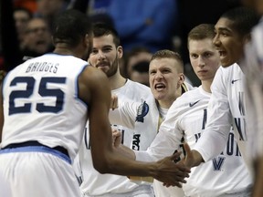 Villanova's Mikal Bridges, left, and teammates celebrate at the end of an NCAA men's college basketball tournament regional semifinal against West Virginia, Friday, March 23, 2018, in Boston.