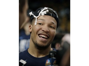 Villanova's Jalen Brunson celebrates after cutting a piece of net following the team's win over Texas Tech in an NCAA men's college basketball tournament regional final, Sunday, March 25, 2018, in Boston. Villanova won 71-59 to advance to the Final Four.