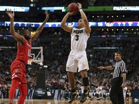 Purdue's Carsen Edwards, right, shoots against Texas Tech's Niem Stevenson during the first half of an NCAA men's college basketball tournament regional semifinal Friday, March 23, 2018, in Boston.