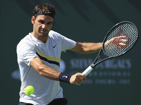 Roger Federer returns a shot to Filip Krajinovic during the third round of the BNP Paribas Open tennis tournament at the Indian Wells Tennis Garden in Indian Wells, Calif., Monday, March 12, 2018.