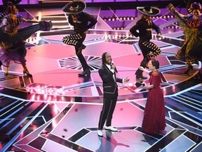REMOVES INCORRECT LAST NAME FOR MIGUEL - Miguel, left, and Natalia Lafourcade perform "Remember Me" from "Coco" at the Oscars on Sunday, March 4, 2018, at the Dolby Theatre in Los Angeles.