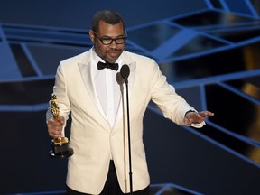 Jordan Peele accepts the award for best original screenplay for "Get Out" at the Oscars on Sunday, March 4, 2018, at the Dolby Theatre in Los Angeles.