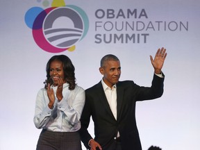 FILE - In this Oct. 13, 2017 file photo, former President Barack Obama, right, and former first lady Michelle Obama arrive for the first session of the Obama Foundation Summit in Chicago. Barack Obama and Netflix reportedly are negotiating a deal for the former president and his wife, Michelle, to produce shows exclusively for the streaming service. The proposed deal was reported Friday, March 9, 2018, by The New York Times, which cited people familiar with the discussions who were not identified.
