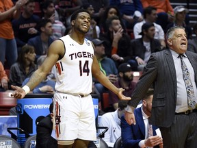 Auburn guard Malik Dunbar (14) reacts alongside head coach Bruce Pearl during the second half of a first-round NCAA college basketball tournament game against Charleston,Friday, March 16, 2018, in San Diego.