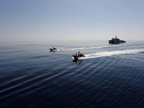 FILE - In this Feb. 26, 2017 file photo, two U.S. Coast Guard fast boats carrying suspects detained in prior drug interdiction operations are transferred from the USCG cutter Mohawk, seen in the background, to the USCG cutter Stratton, in the eastern Pacific Ocean. The U.S. Coast Guard is teaming up with the Mexican and Colombian navies off South America's Pacific coast to go after seafaring smugglers, opening a new front in the drug war.