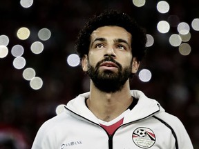 FILE - In this Oct. 8, 2017 file photo, Egypt's Mohamed Salah sings the national anthem before the 2018 World Cup group E qualifying soccer match between Egypt and Congo at the Borg El Arab Stadium in Alexandria. Egypt's first World Cup warmup will be against Portugal in a match that could have two of the most prolific scorers in soccer going up against each other. The Egyptians will be led by Liverpool forward Mohammed Salah. On the other side is Cristiano Ronaldo.