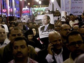 FILE - In this Monday, March 19, 2018 file photo, supporters of Egyptian President Abdel-Fattah el-Sissi hold posters during a campaign rally, near the Gamaleya district where el-Sissi was born, in Cairo, Egypt. This week's presidential election is not about who wins -- that was settled long ago -- but about how many people bother to cast ballots. Authorities hope that enough people will vote for el-Sissi to lend legitimacy to the election in which the only other candidate is an obscure politician who has made no effort to challenge him.