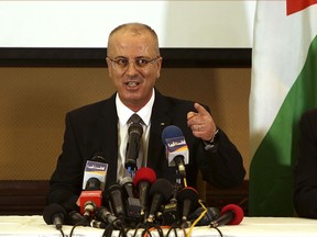 FILE - In this Dec. 7, 2017 file photo, Palestinian Prime Minister Rami Hamdallah speaks during a press conference in Gaza City. On Tuesday March 13, 2018 an explosion struck the convoy of the Hamdallah during a rare visit to Gaza, in what his Fatah party called an assassination attempt it blamed on Gaza militants. Hamdallah was unharmed and went on to inaugurate a long-awaited sewage plant project in the northern part of the strip.