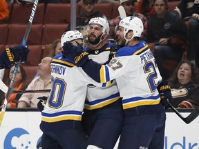 St. Louis Blues' Robert Bortuzzo, center, celebrates his goal with Nikita Soshnikov, left, of Russia, and Alex Pietrangelo during the first period of an NHL hockey game against the Anaheim Ducks, Monday, March 12, 2018, in Anaheim, Calif.