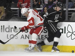 Detroit Red Wings right wing Gustav Nyquist, of Sweden and Los Angeles Kings defenseman Paul LaDue battle on the boards during the first period of an NHL Hockey game, Thursday, March 15, 2018, in Los Angeles.