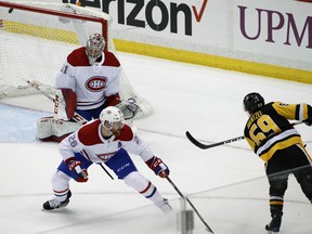 Pittsburgh Penguins' Jake Guentzel gets a shot past Canadiens goaltender Carey Price and defenceman Jeff Petry for a goal during the third period of their game in Pittsburgh on Wednesday night.