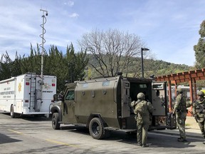 Law enforcement members stage near the Veterans Home of California after reports of an active shooter Friday, March 9, 2018, in Yountville, Calif. Napa County Fire captain Chase Beckman says a gunman has taken hostages at the veterans home in California.