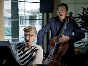 FILE - In this March 2, 2018, file photo, Marjorie Keith, left, plays an impromptu duet of "God Bless America" with cellist Yo-Yo Ma at the Valencia Terrace in Corona, Calif. The Massachusetts Institute of Technology says Ma will visit the campus Monday, March 19, 2018, to deliver a talk titled "Yo-Yo Ma: Culture, Understanding and Survival" as part of a lecture series featuring figures in modern thought.