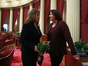 In this photo taken Thursday, March 15, 2018, state Sen. Toni Atkins, D-San Diego, right, talks with Senate Republican Leader Pat Bates, of Laguna Niguel, after the Senate session in Sacramento, Calif. Atkins will make history Wednesday, March 21, 2018, when she becomes the first woman and first lesbian to hold the California Senate's top job.