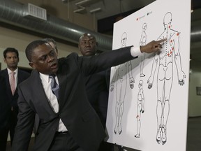 Pathologist Dr. Bennet Omalu points to details in a diagram showing the gunshot wounds he found on the body of Stephon Clark who was shot by Sacramento police, during a news conference Friday, March 30, 2018, in Sacramento, Calif. Omalu was hired by the attorneys of the Clark family to perform the independent autopsy.