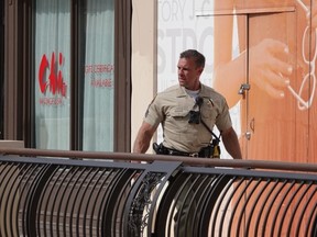 A law enforcement officer walks through The Oaks mall in Thousand Oaks, Calif., about 40 miles (64 kilometers) west of Los Angeles on Saturday, March 17, 2018. Authorities said a gunman shot and killed one person and then turned the gun on himself at the shopping center on Saturday.