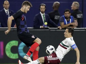 Croatia forward Andrej Kramaric (9) and Mexico midfielder Hirving Lozano (8) compete for control of the ball during the first half of an international friendly soccer match in Arlington, Texas, Tuesday, March 27, 2018.