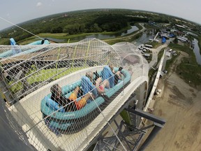 FILE - In this July 9, 2014, file photo, riders go down the water slide called "Verruckt" at Schlitterbahn Waterpark in Kansas City, Kan. A former executive with the Kansas water park where a 10-year-old boy died on the giant waterslide has been charged with involuntary manslaughter. Tyler Austin Miles, an operations director for Schlitterbahn, was booked into the Wyandotte County jail Friday, March 23, 2018 and is being held on $50,000 bond. Caleb Schwab died in August 2016 on the 17-story Verruckt water slide at the park in western Kansas City, Kansas.
