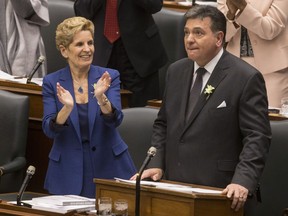 Ontario's Premier Kathleen Wynne applauds Provincial Finance Minister Charles Sousa as the Ontario Provincial Government delivers its 2018 Budget , at the Queens Park Legislature in Toronto, on Wednesday March 28, 2018.