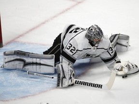 Los Angeles Kings goaltender Jonathan Quick falls on the ice to cover the puck after stopping a shot against the Colorado Avalanche in the first period of an NHL hockey game Thursday, March 22, 2018, in Denver.