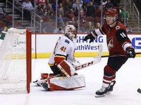 Max Domi of the Arizona Coyotes scores against Calgary Flames' goaltender Mike Smith during NHL action Monday night in Glendale, Az. The Coyotes were 5-2 winners, seriously damaging the Flames' hopes of securing a playoff position in the West Conference with eight games remaining on the schedule.