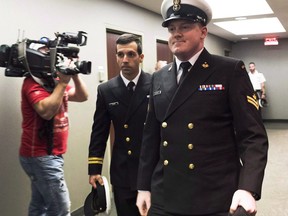 Accused Master Seaman Daniel Cooper, right, arrives for his standing court martial case in Halifax on Tuesday Sept. 26, 2017. Cooper faces one charge of sexual assault, and one charge of ill treatment of a subordinate, arising out of incidents that allegedly occurred in November 2015 on board HMCS Athabaskan near Rota, Spain.