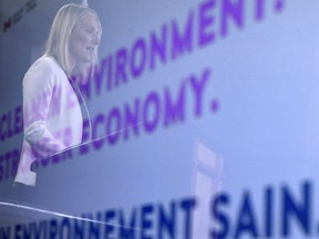 Minister of Environment and Climate Change Catherine McKenna is reflected in a TV screen during a press conference in Ottawa on Thursday, Feb. 8, 2018.