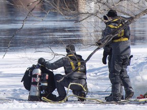 Police divers search the shores of the Riviere des Prairies on Montreal's north shore, Monday, March 19, 2018. Montreal police say they believe a boy who has been missing for 10 days more than likely fell into a river.