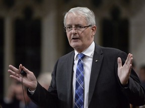 Grain farmers in Western Canada say billions of dollars are at stake unless the government pushes forward with a fix to address a serious shortage of rail cars to move crops to market. Transport Minister Marc Garneau rises in the House of Commons in Ottawa on Tuesday, October 24, 2017.